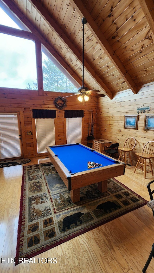 recreation room featuring high vaulted ceiling, wooden walls, light hardwood / wood-style floors, pool table, and beam ceiling