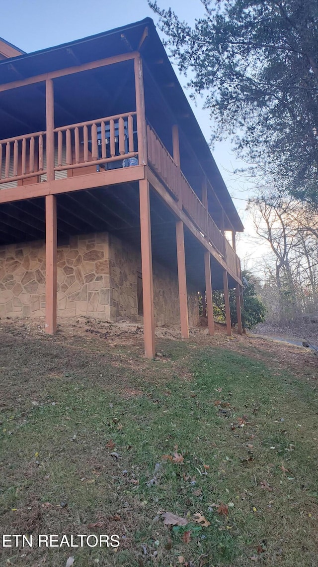 view of side of property featuring a wooden deck