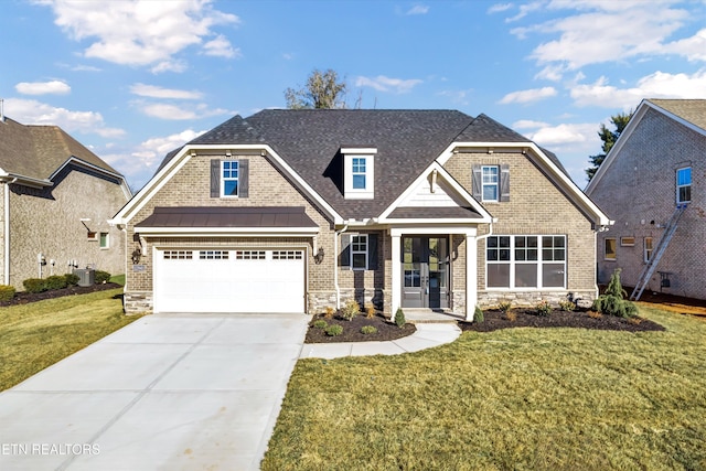 craftsman house with driveway, a standing seam roof, stone siding, and a front yard