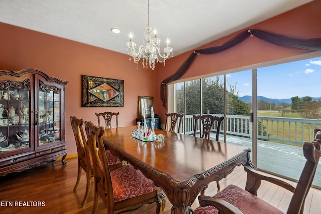 dining area featuring a chandelier, wood-type flooring, and a mountain view