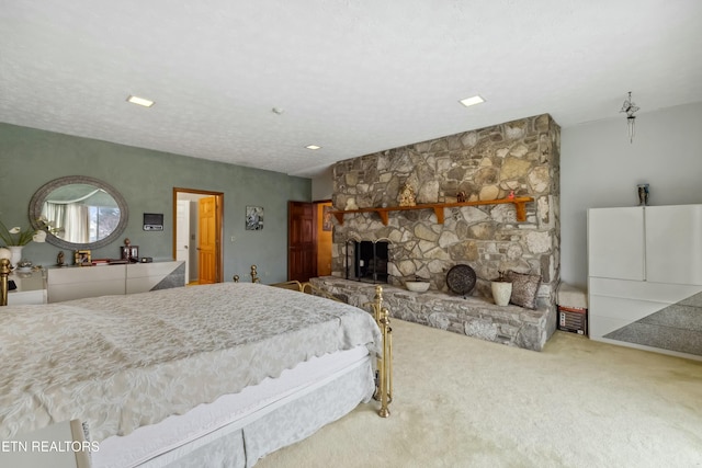 carpeted bedroom with a fireplace and a textured ceiling