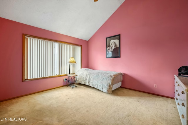 carpeted bedroom with lofted ceiling