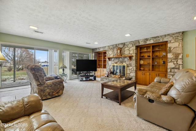 carpeted living room featuring a fireplace and a textured ceiling