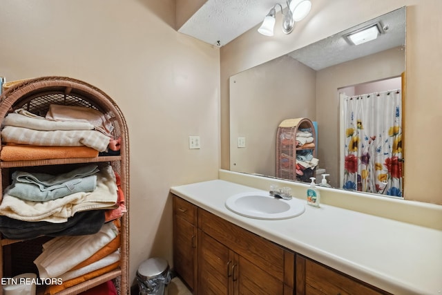 bathroom featuring vanity and a textured ceiling