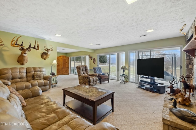 living room featuring light carpet and a textured ceiling