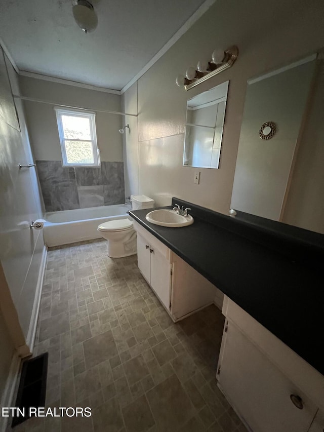 full bathroom with vanity, toilet, tiled shower / bath, and crown molding