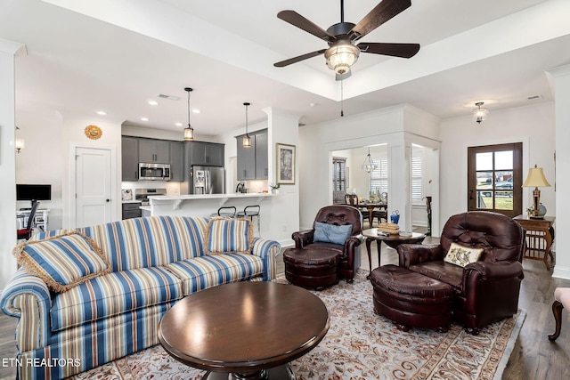 living room featuring ceiling fan and hardwood / wood-style flooring