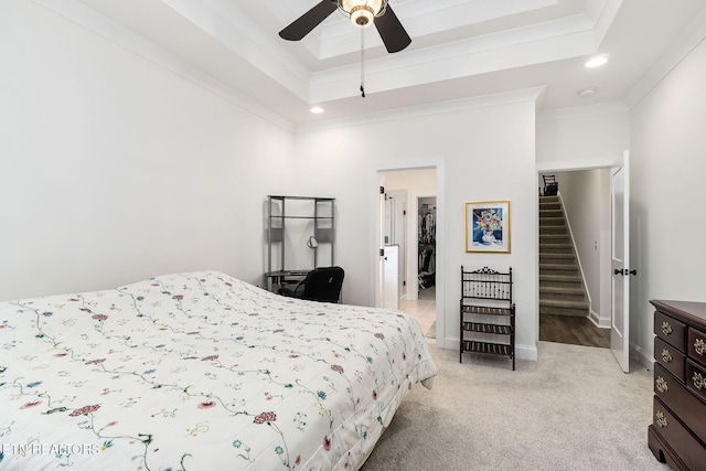 bedroom with light carpet, a raised ceiling, ceiling fan, and crown molding