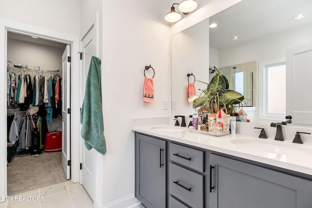 bathroom with vanity and a shower with door