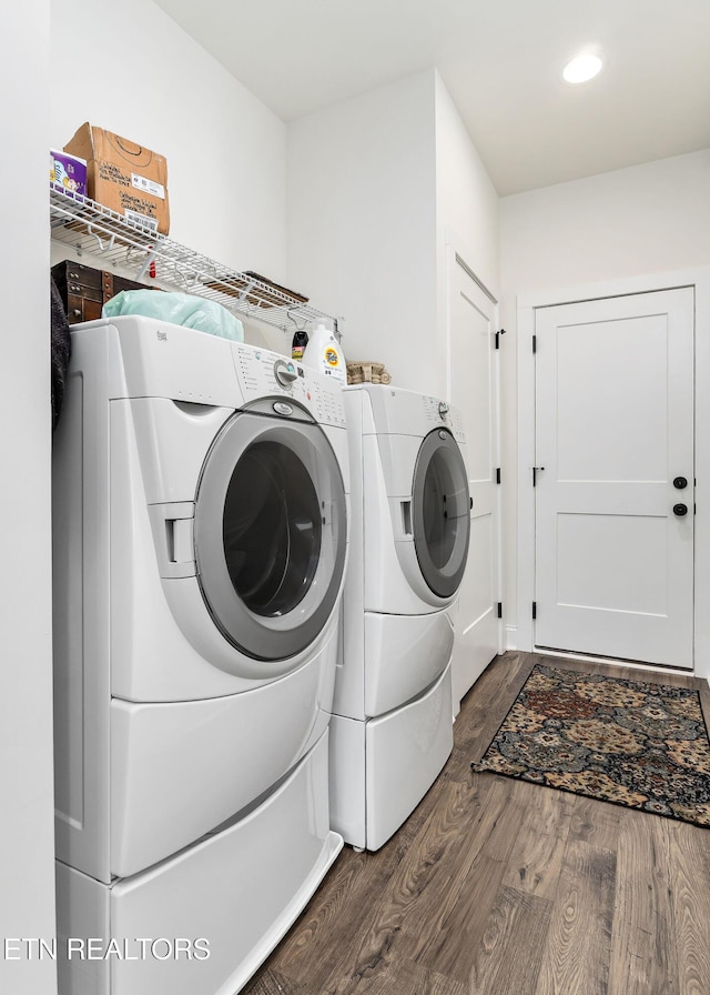 laundry area with dark hardwood / wood-style floors and independent washer and dryer