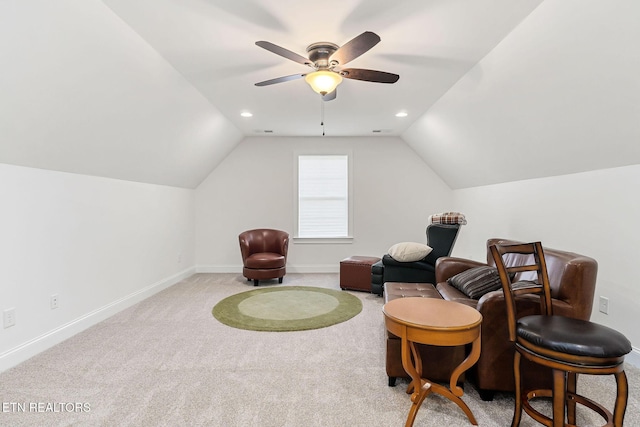 living area featuring ceiling fan, light colored carpet, and vaulted ceiling