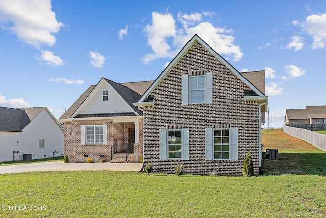 view of front property with a front yard and central AC