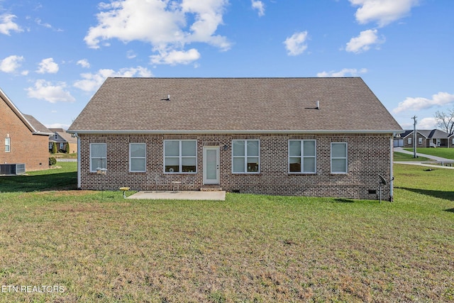 back of property with a lawn, central air condition unit, and a patio