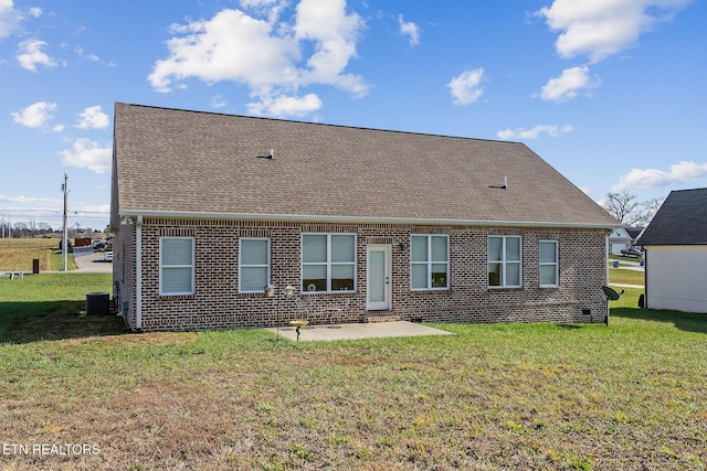 rear view of house featuring central air condition unit, a yard, and a patio