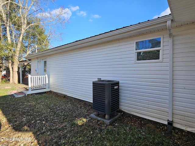 view of side of home with central AC unit