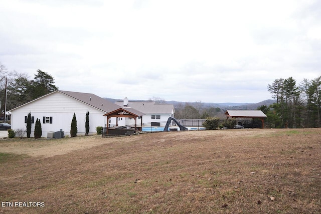 exterior space featuring a front yard and central AC