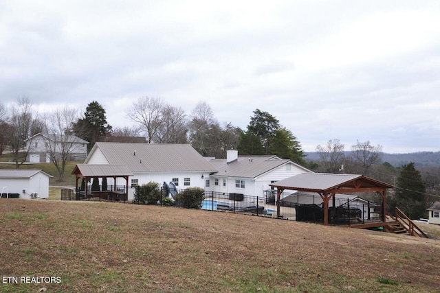 rear view of property featuring a gazebo