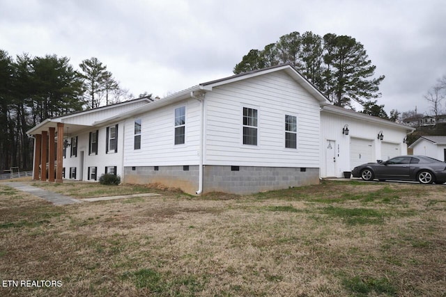 view of property exterior featuring a garage and a lawn