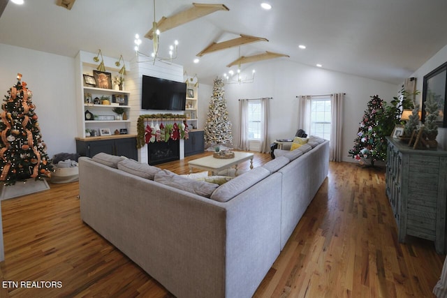 living room with dark hardwood / wood-style flooring, vaulted ceiling, and a notable chandelier