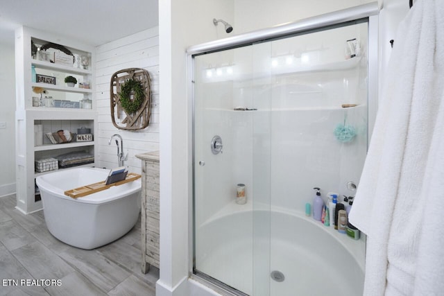 bathroom with independent shower and bath and wood walls