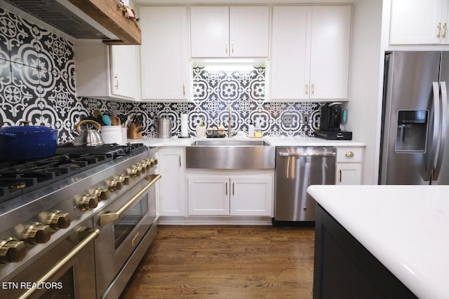 kitchen featuring backsplash, sink, white cabinets, and appliances with stainless steel finishes