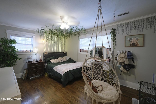 bedroom featuring ceiling fan, crown molding, and dark wood-type flooring