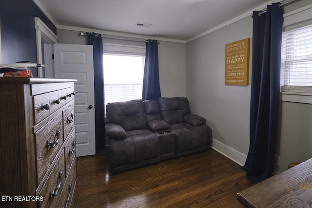 living area with dark hardwood / wood-style flooring and crown molding