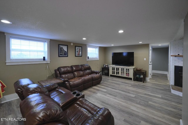 living room featuring a fireplace and light hardwood / wood-style flooring