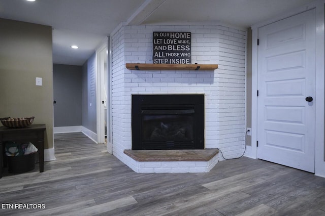 unfurnished living room featuring a fireplace and hardwood / wood-style floors