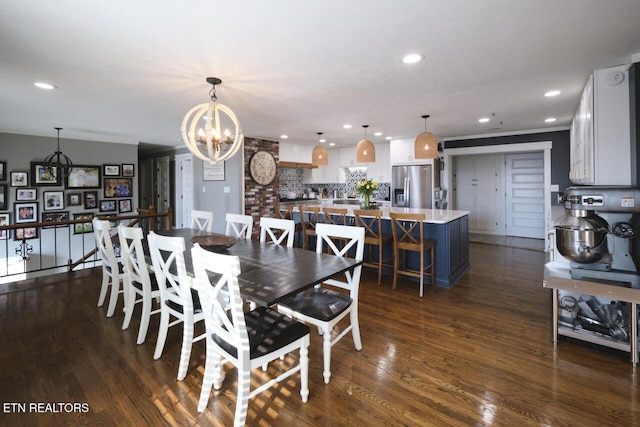 dining area with an inviting chandelier and dark hardwood / wood-style floors