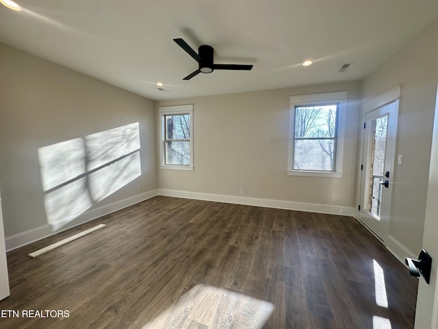 unfurnished room featuring ceiling fan and dark hardwood / wood-style floors