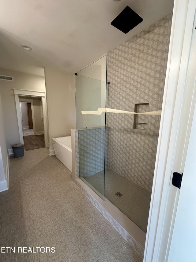 bathroom featuring separate shower and tub