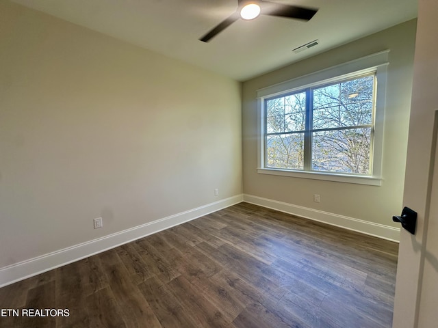 spare room featuring ceiling fan and dark hardwood / wood-style flooring