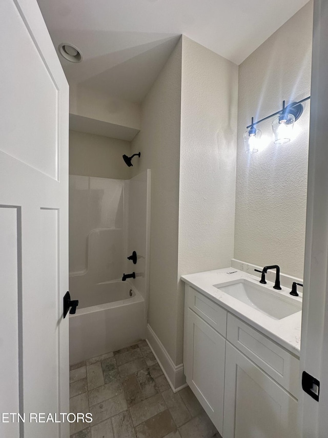 bathroom featuring  shower combination and vanity