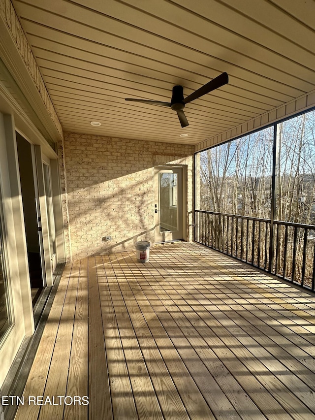 wooden deck featuring ceiling fan