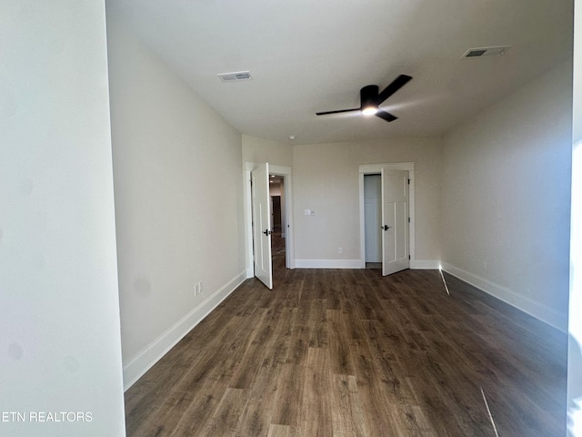 empty room featuring dark hardwood / wood-style floors and ceiling fan