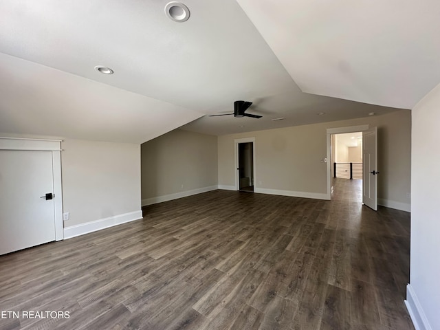 bonus room with baseboards, lofted ceiling, dark wood-type flooring, and a ceiling fan