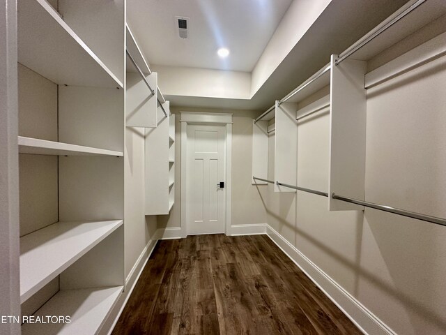 spacious closet with visible vents and dark wood-style flooring