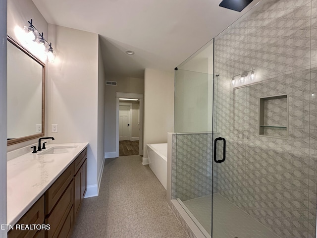 full bath featuring visible vents, baseboards, a stall shower, a bath, and vanity