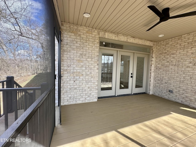 deck with french doors and a ceiling fan