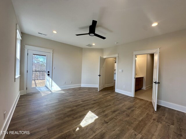 unfurnished bedroom featuring visible vents, baseboards, dark wood-style floors, and access to outside