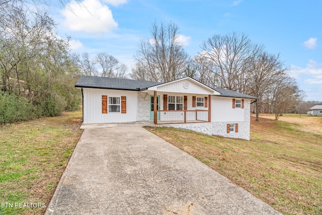 single story home with covered porch and a front lawn