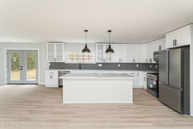 kitchen featuring appliances with stainless steel finishes, white cabinetry, and a kitchen island