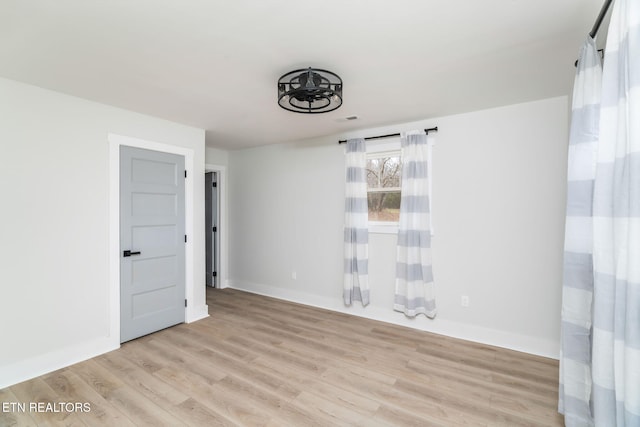 spare room featuring light hardwood / wood-style flooring