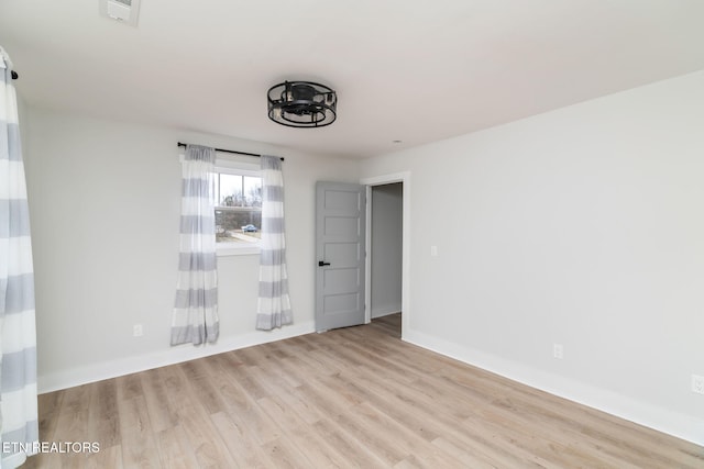 spare room with light hardwood / wood-style flooring