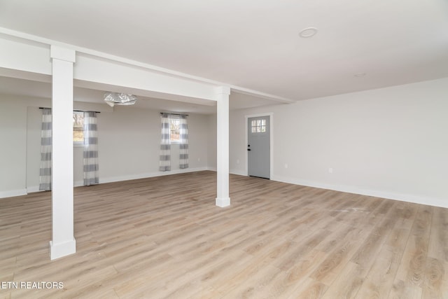 basement featuring light hardwood / wood-style flooring and a wealth of natural light