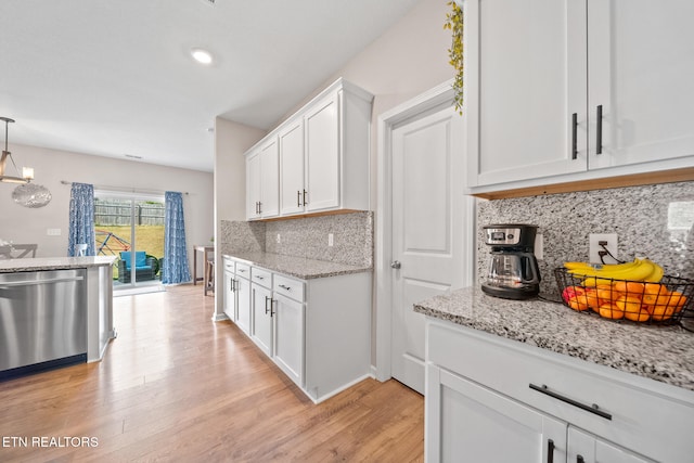 kitchen with decorative backsplash, white cabinets, pendant lighting, light hardwood / wood-style flooring, and dishwasher