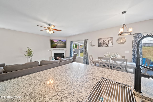 kitchen with pendant lighting and ceiling fan with notable chandelier