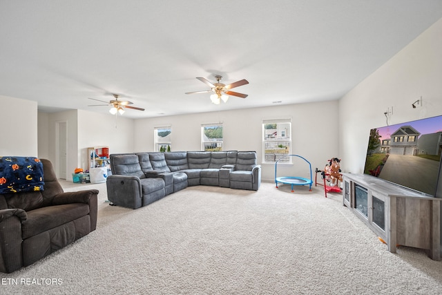 carpeted living room with ceiling fan