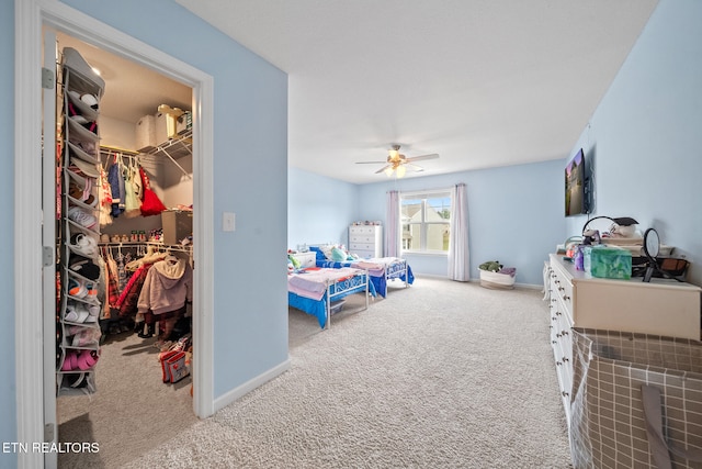 bedroom featuring carpet floors, a spacious closet, a closet, and ceiling fan